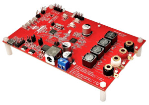 Red electronics development board with capacitors, connectors, and power jack on a white background, used for prototyping.